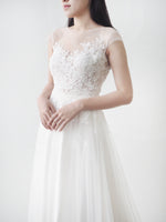 Cap sleeve tulle gown with pearl buttons